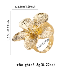 Detail of golden flower ring with brushed texture and adjustable band dimensions