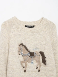 Close-up of intricate horse jacquard and embroidery on cream wool blend sweater