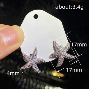 Detail view of 17mm starfish stud earrings with cubic zirconia pavé and size dimensions
