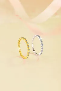 Close-up of gold and silver S925 sterling silver rings with olive patterns and zircons