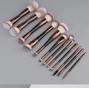 Detailed close-up of 12 dual-ended makeup brushes with rose gold ferrules and matte handles