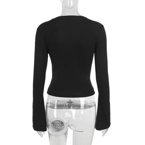 Detail view of the back of a black ribbed knit slim-fit long sleeve top on a mannequin