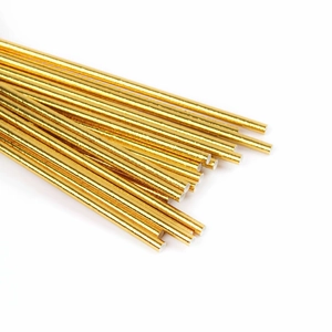Macro detail of metallic gold paper straws in a fan arrangement for party decoration