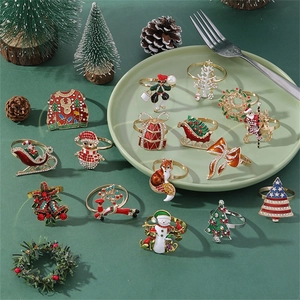 Detailed close-up of colorful rhinestone Christmas tree and elk festive napkin rings set