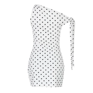 Detail of white polka dot dress featuring a one-shoulder cut and adjustable shoulder tie