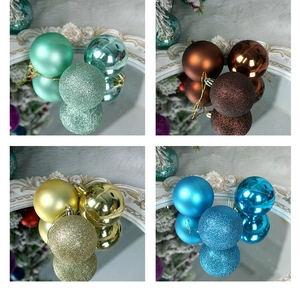 Detail of Christmas balls in matte, glossy, and glitter finishes on an elegant tray