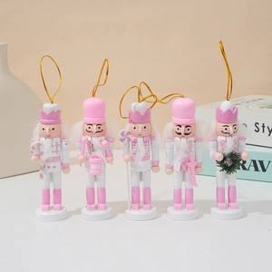 Set of five pink and white wooden nutcracker soldier ornaments with golden hanging strings