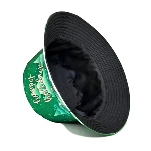 Detail of Christmas bucket hat with festive green print and Happy Holidays text