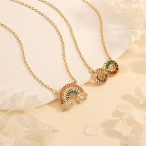 Detail shot of gold necklaces with rainbow and infinity pendants set with colorful zircons