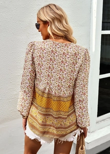 Back view of bohemian floral print long sleeve blouse with ethnic yellow patterns