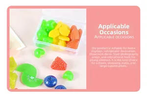 Detailed view of assorted PVC artificial fruit slices and berries in a storage box