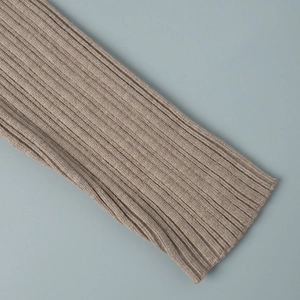 Detailed macro view of khaki knit dress sleeve showing thick vertical ribbed texture