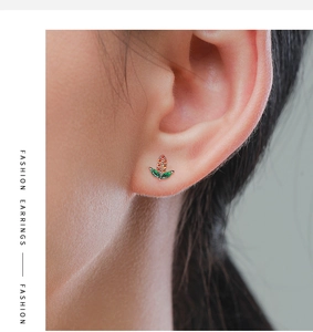 Close-up of mini corn stud earrings with colorful crystals on model ear for detail