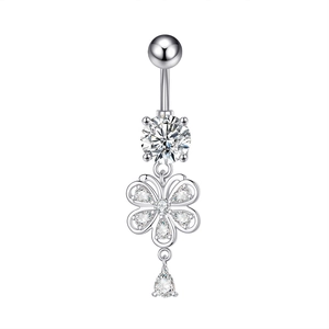 Macro detail of silver navel ring featuring a floral design and teardrop zircon stone