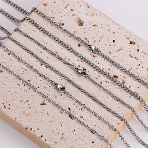 Minimalist silver Cuban chain necklaces displayed on stone with secure lobster clasps