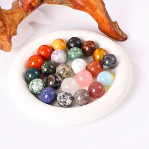 Variety of 20mm natural crystal and agate stone spheres displayed in a white ceramic dish