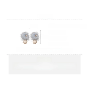 Detail of 18K gold-plated earrings with grey fur balls, white pearls, and zircon accents
