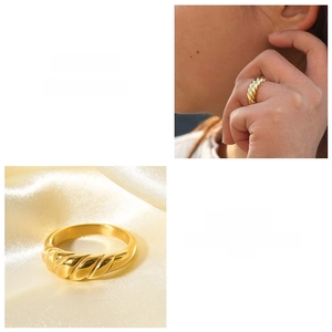 Macro detail of 18k gold plated croissant ring showing twisted texture and hand modeling