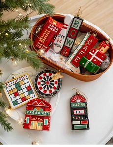 Close-up of retro Christmas tree ornaments featuring vintage bus, cafe sign, and bingo motifs