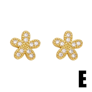 Minimalist gold flower stud earrings with sparkling cubic zirconia and granulation details