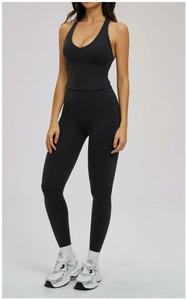 Detail view of black yoga set with V-neck sports bra and high-waisted leggings