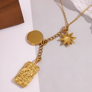 Detailed view of 18K gold plated necklace featuring square, round and star pendants