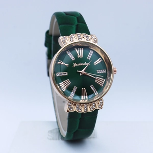 Detailed view of dark green leather strap and crystal lugs on the rose gold watch