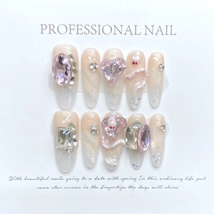 Close-up of pink gradient handmade press-on nails with 3D white snake and heart gems