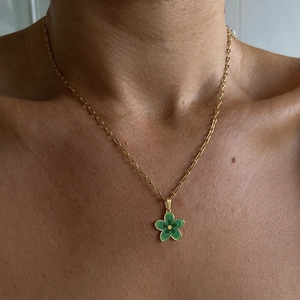 Detailed view of layered 18k gold plated paperclip chain with a green flower pendant