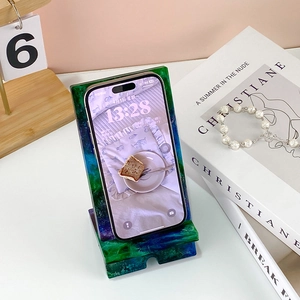 Detail of L-shaped epoxy resin phone stand with nebula pattern and charging port