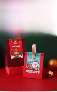 Detail of Christmas paper gift box with leather handle and festive cartoon illustration