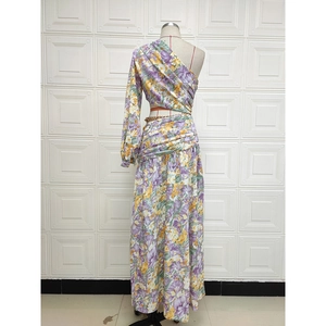 Detail of floral one-shoulder dress with side waist cutout and asymmetric ruffled hemline