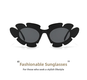 Detail view of irregular black wavy frame and dark lenses of floral sunglasses