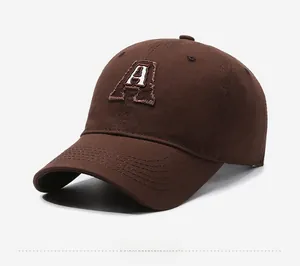 Close-up detail of white letter A embroidery on coffee brown cotton baseball cap