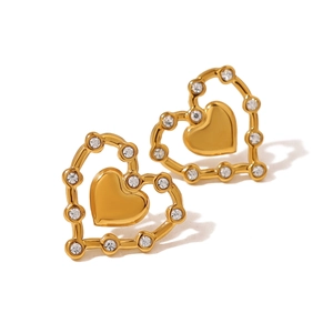 Close-up of gold heart-shaped stud earrings with sparkling crystal accents