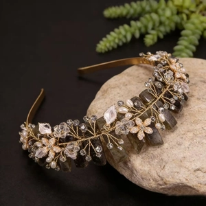 Detail of handmade crown headband with pink crystals, pearls and gold wire craft