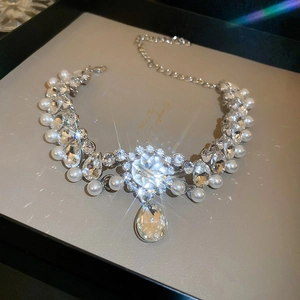 Close-up of sparkling waterdrop rhinestones and white pearls on a luxury choker necklace