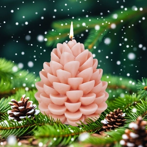 Christmas pinecone scented candle in pink wax with snow-covered pine branches backdrop