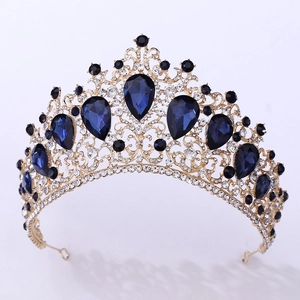 Detailed view of golden metal crown with blue teardrop crystals and clear rhinestones