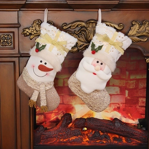 Luxurious Santa and Snowman stockings hanging on a rustic wooden fireplace with warm lighting