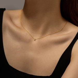 Elegant gold S925 sterling silver necklace with teardrop crystal worn by a model