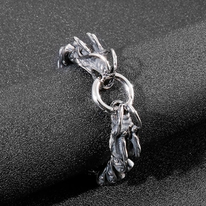 Macro detail of retro stainless steel double dragon head bracelet with antique finish
