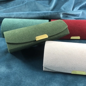 Velvet travel jewelry boxes in multiple colors with golden metal buckles and plush texture
