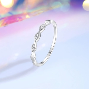 Minimalist S925 sterling silver wave ring with zircons on a dreamy bokeh background