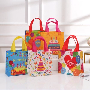 Colorful non-woven birthday party gift bags with festive cake and balloon prints