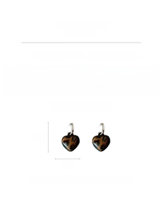 Detail showing heart-shaped leopard print earrings with dimensions and material specs