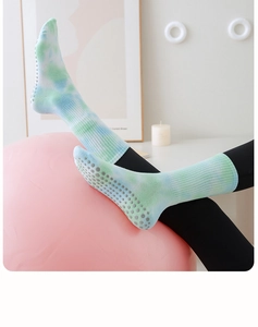 Detailed view of tie-dye yoga socks with non-slip silicone grip dots on the cotton sole