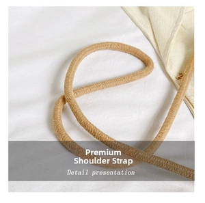Detail shot of the thick beige braided rope shoulder strap for woven bucket bags