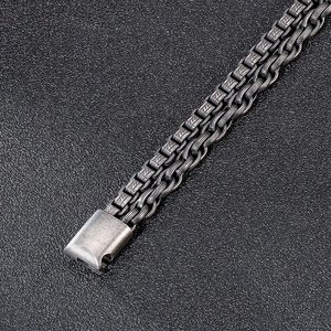 Macro detail of vintage titanium steel chain bracelet with textured square buckle clasp