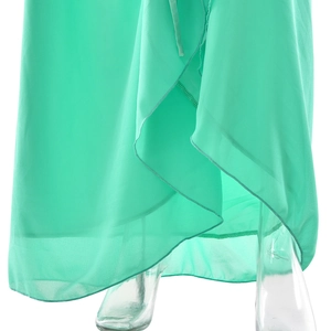 Detail view of turquoise chiffon dress hem with irregular wrap design and light texture
